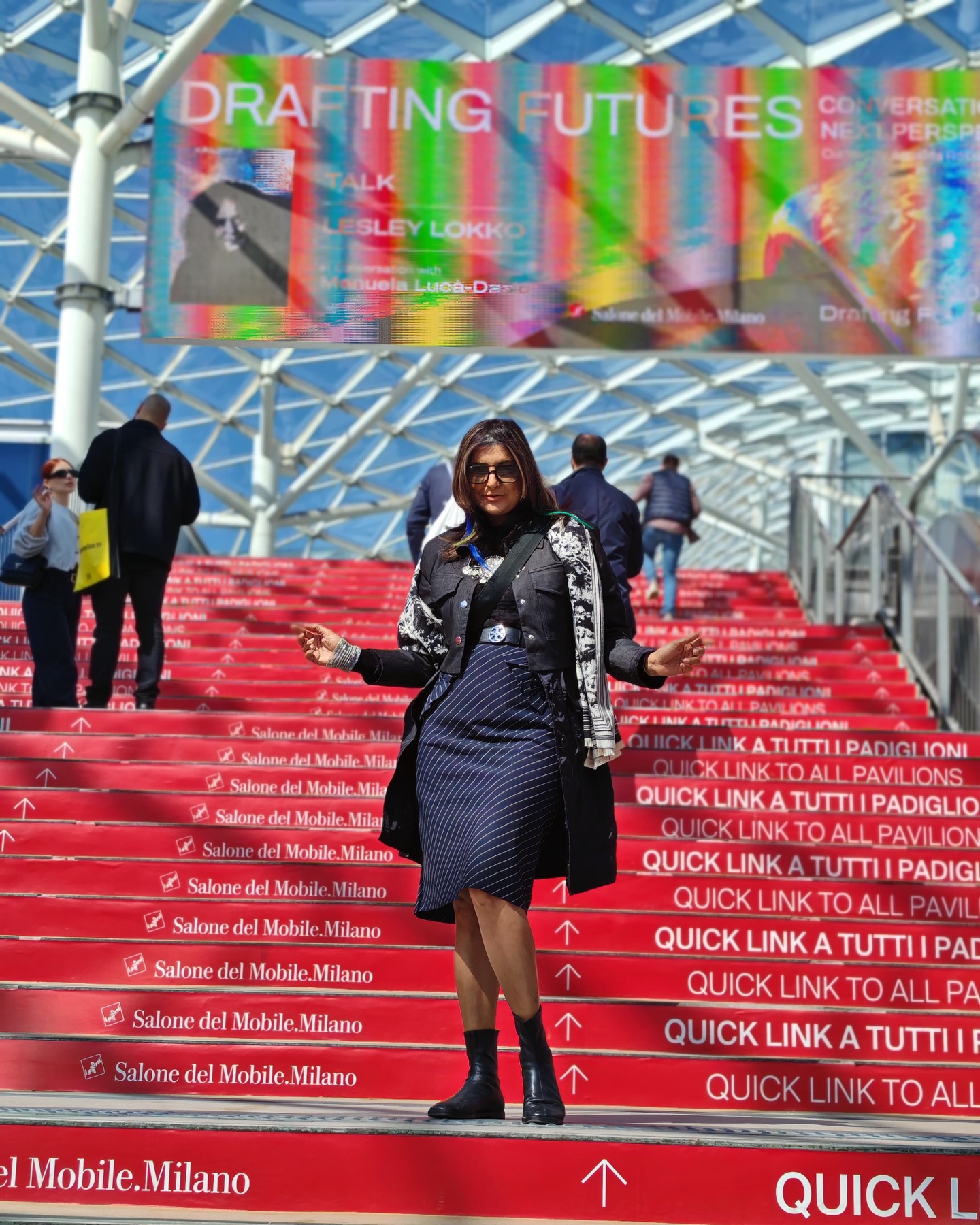 Pallavi on the red stairs of Salone del Mobile in Milan
