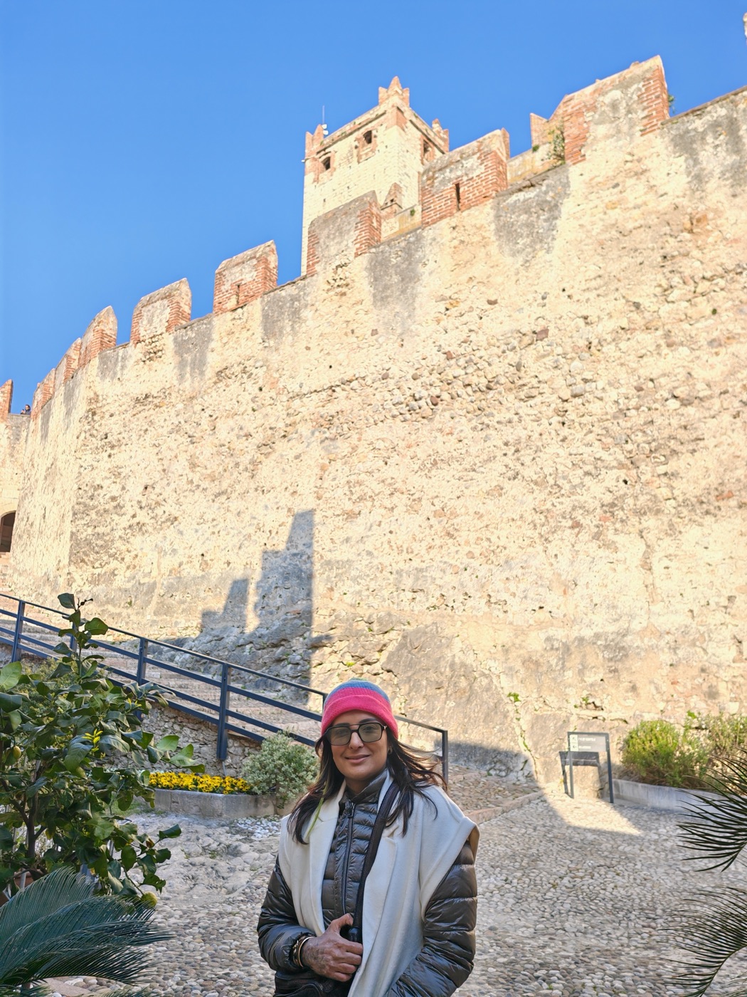 A crenellated castle wall in evening light