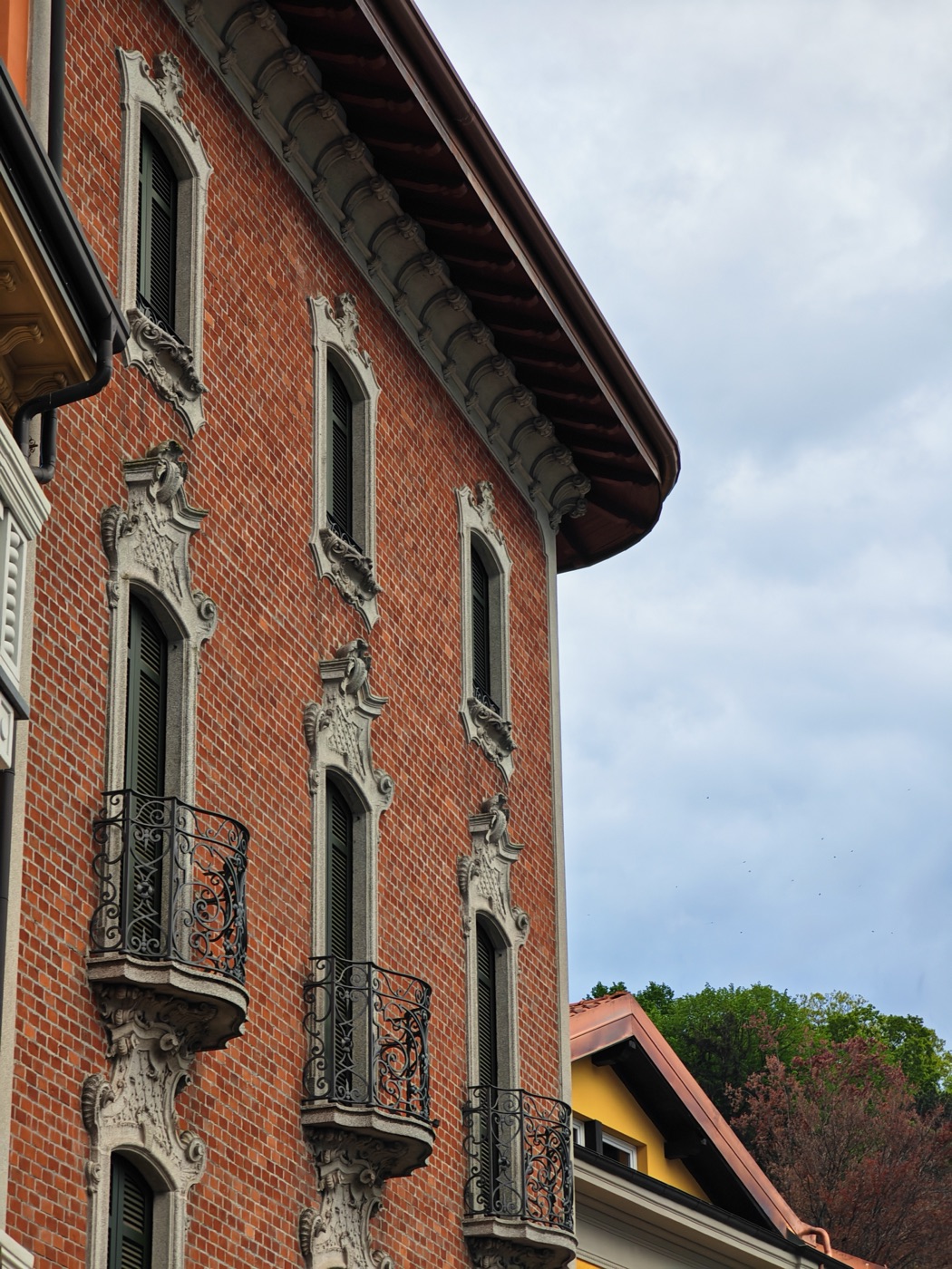 A brick facade with wrought iron balconies