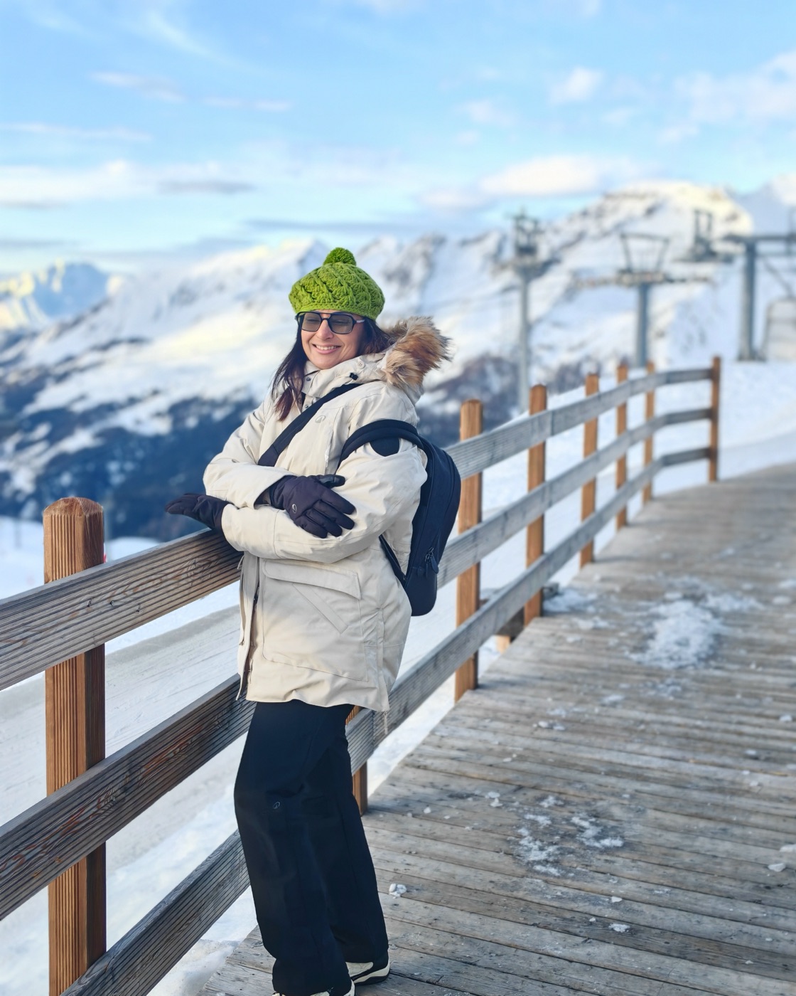 Pallavi on a snowy boardwalk above the valley
